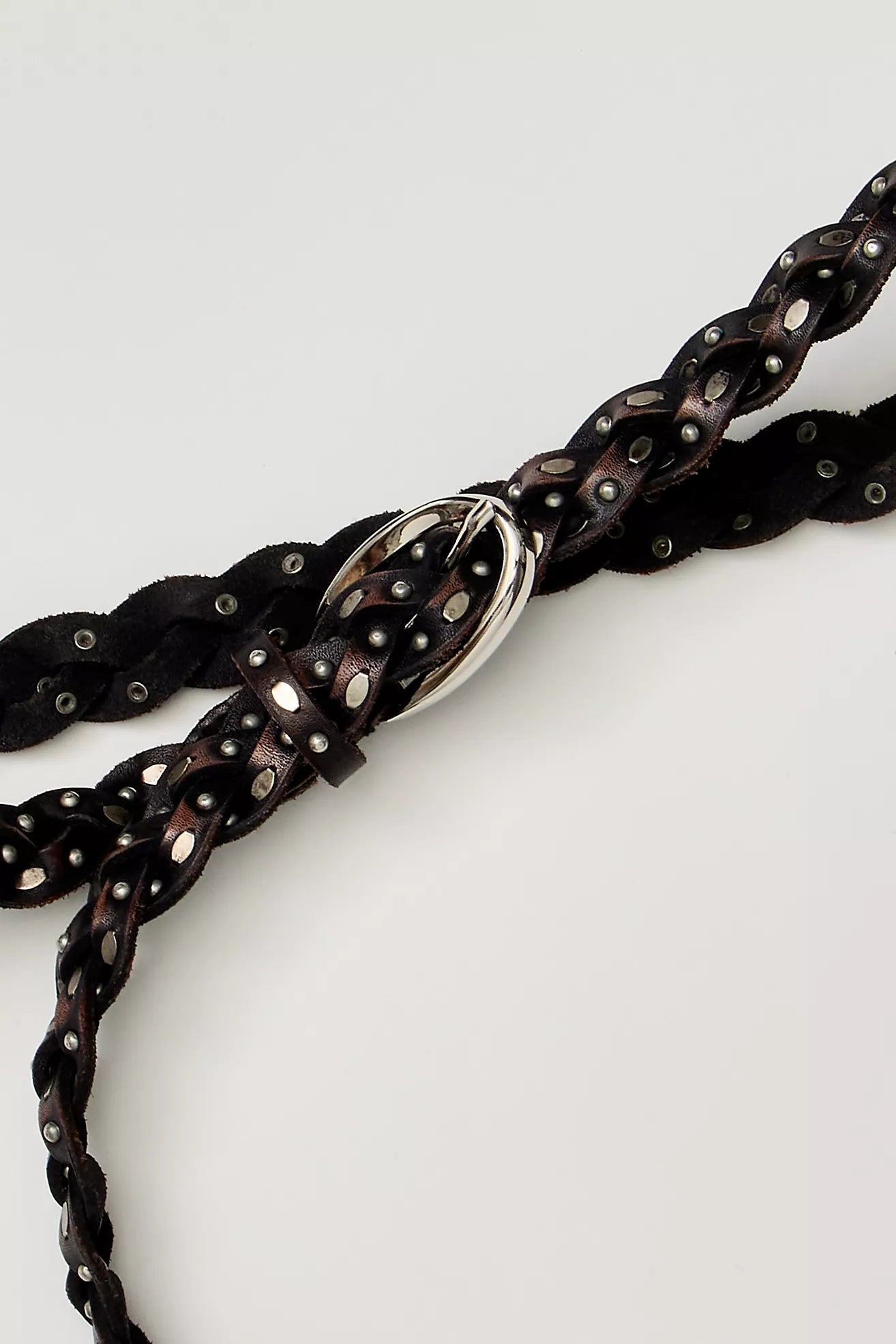 Trestles Clothing Company brown braided leather belt featuring silver metal studs and a polished buckle